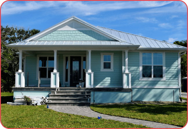 A blue house with a porch and steps leading to the front door.